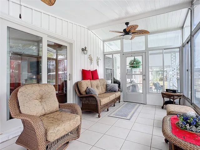a living room with furniture and a floor to ceiling window