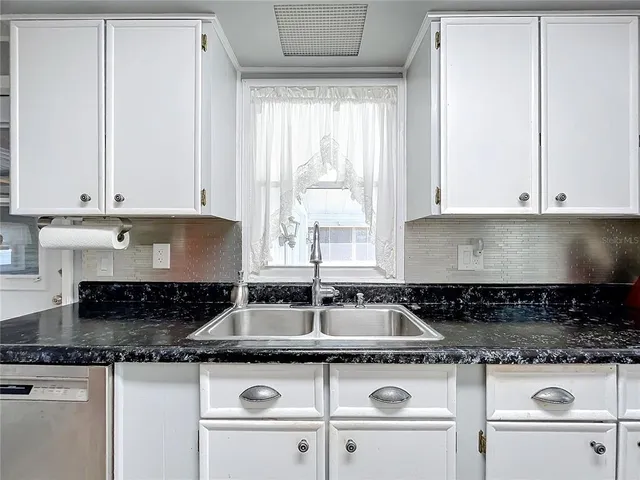 a bedroom with a large bed and a flat tv screen on a dresser