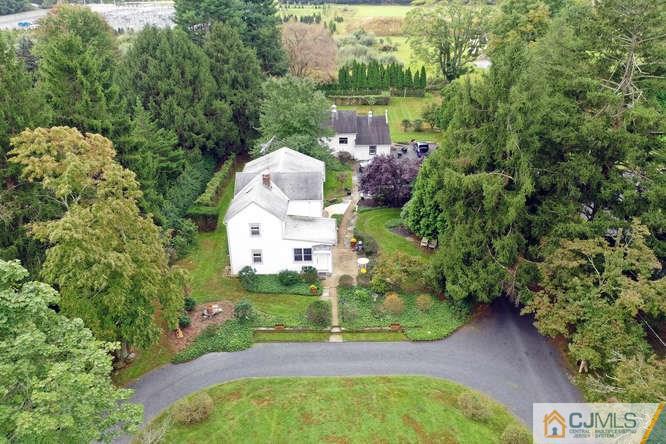 963 Ridge Road Princeton, NJ 08540 - Photo 1 of 25 an aerial view of a house with a yard and large trees