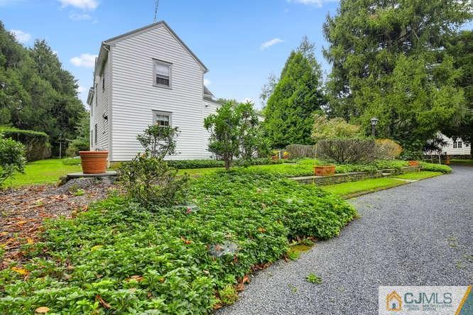 963 Ridge Road Princeton, NJ 08540 - Photo 21 of 25 a view of a house with a yard and potted plants