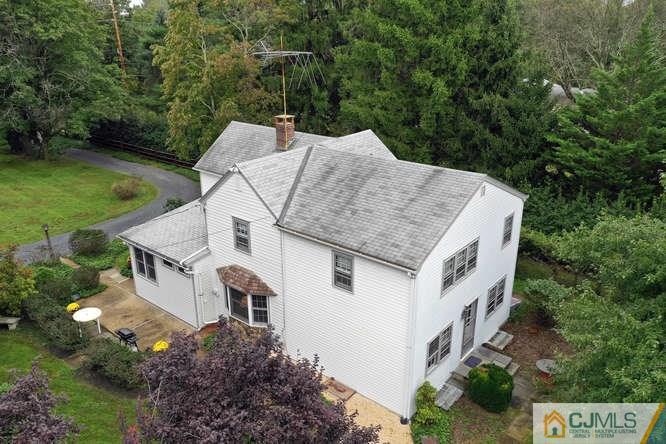 963 Ridge Road Princeton, NJ 08540 - Photo 5 of 25 a aerial view of a house with a yard and large trees