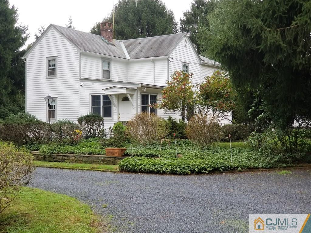 963 Ridge Road Princeton, NJ 08540 - Photo 6 of 25 a view of a white house with a yard and plants
