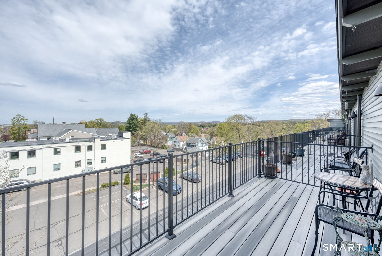 234 South Main Street, Unit 416 Middletown, CT 06457 - Photo 29 of 37 a view of city from a roof deck with furniture