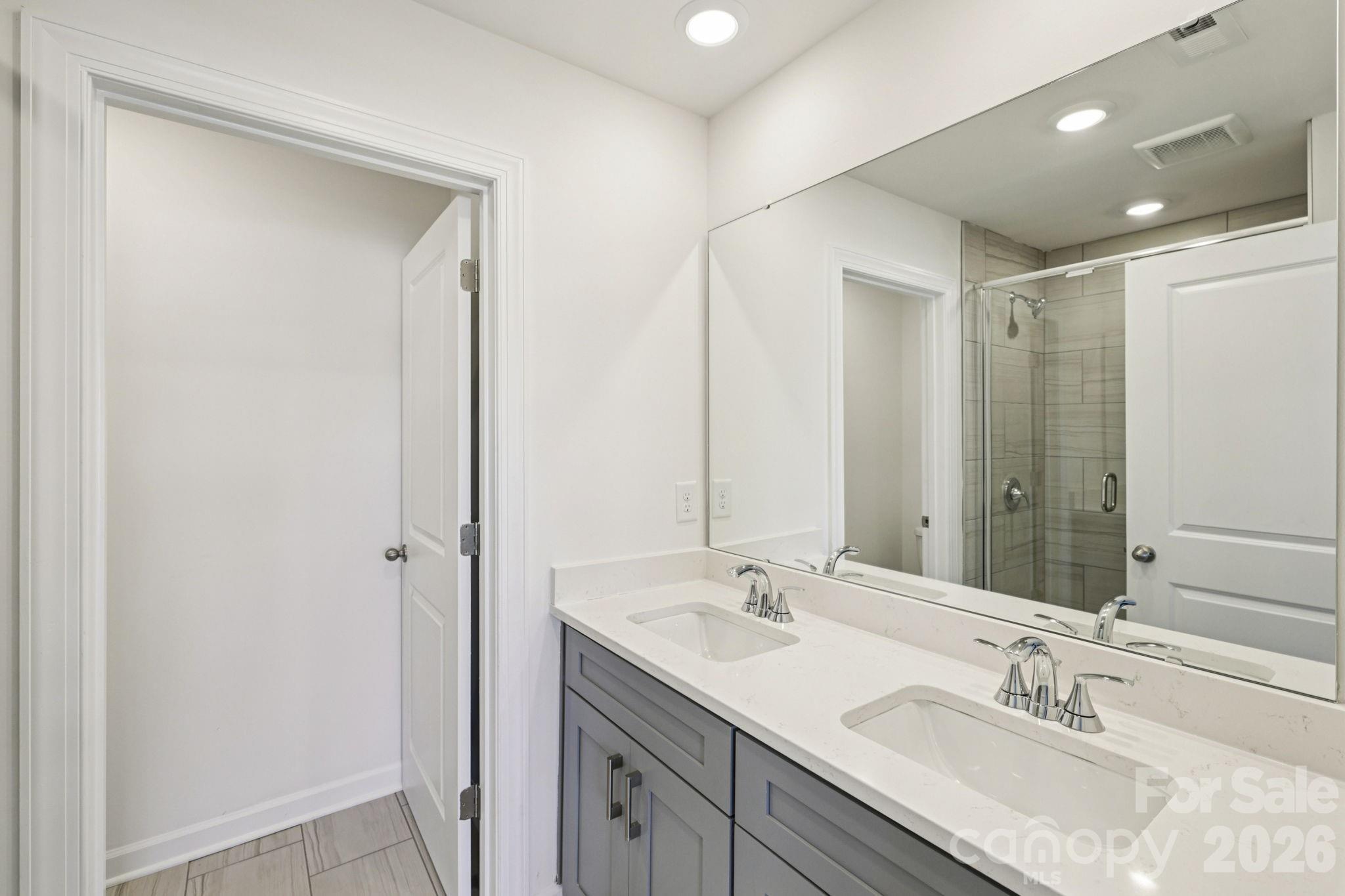 335 Golden Maple Court Fort Mill, SC 29708 - Photo 18 of 26 a bathroom with a sink double vanity and a mirror