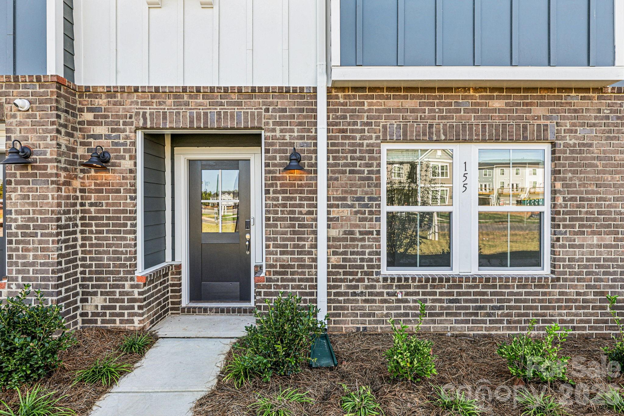 335 Golden Maple Court Fort Mill, SC 29708 - Photo 2 of 26 a front view of a house with a garden