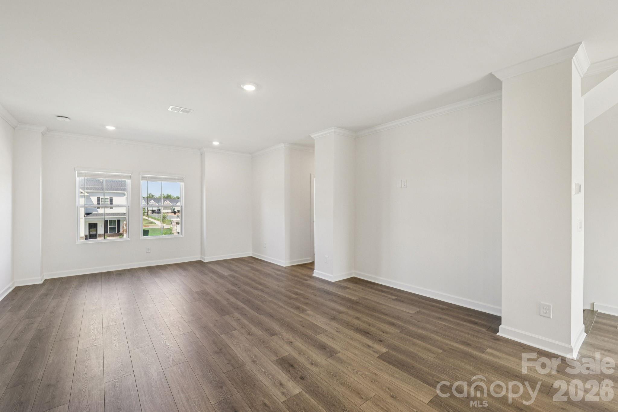335 Golden Maple Court Fort Mill, SC 29708 - Photo 23 of 26 a view of an empty room with wooden floor and a window
