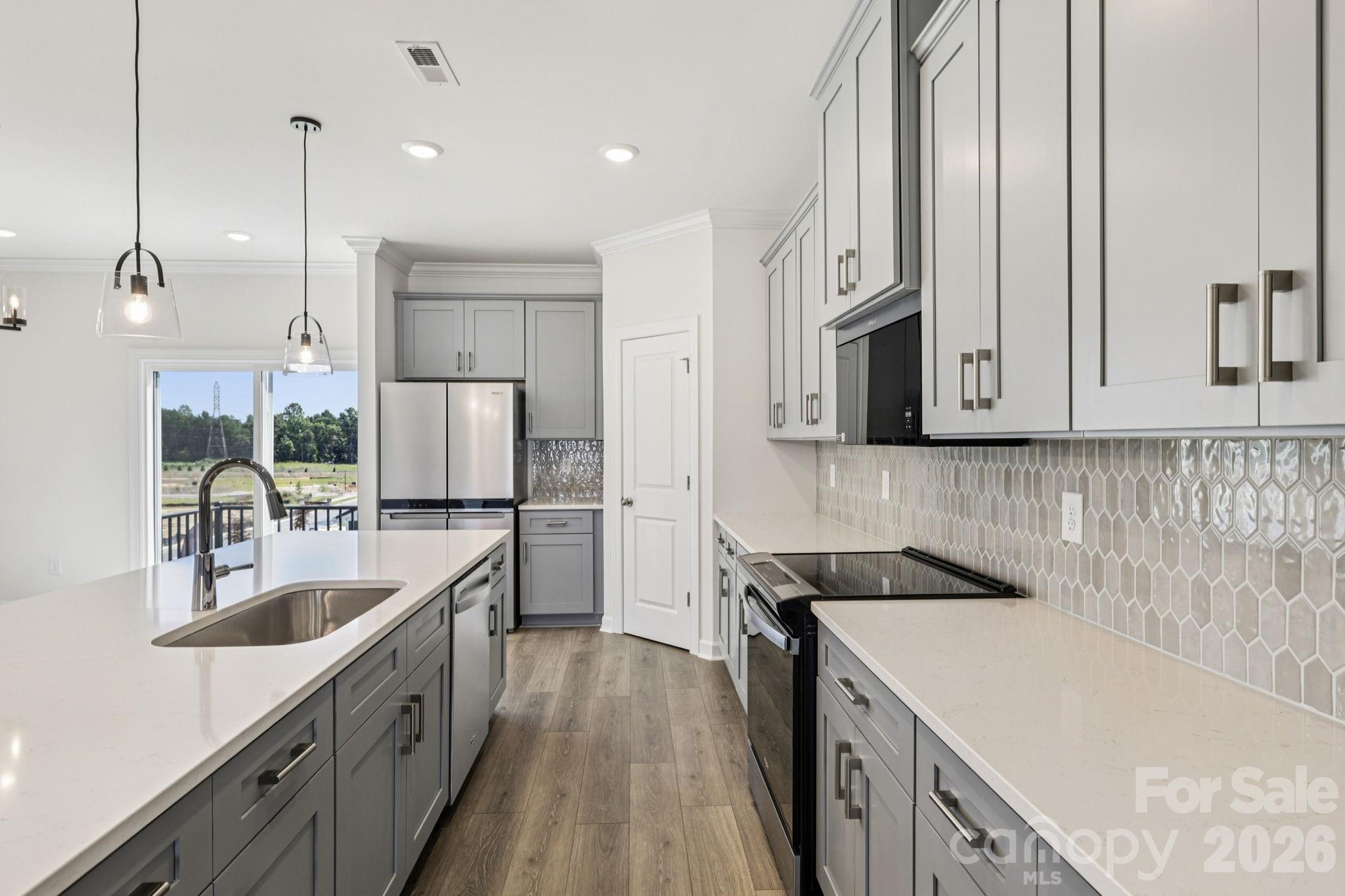 335 Golden Maple Court Fort Mill, SC 29708 - Photo 8 of 26 a kitchen with a sink stove and microwave