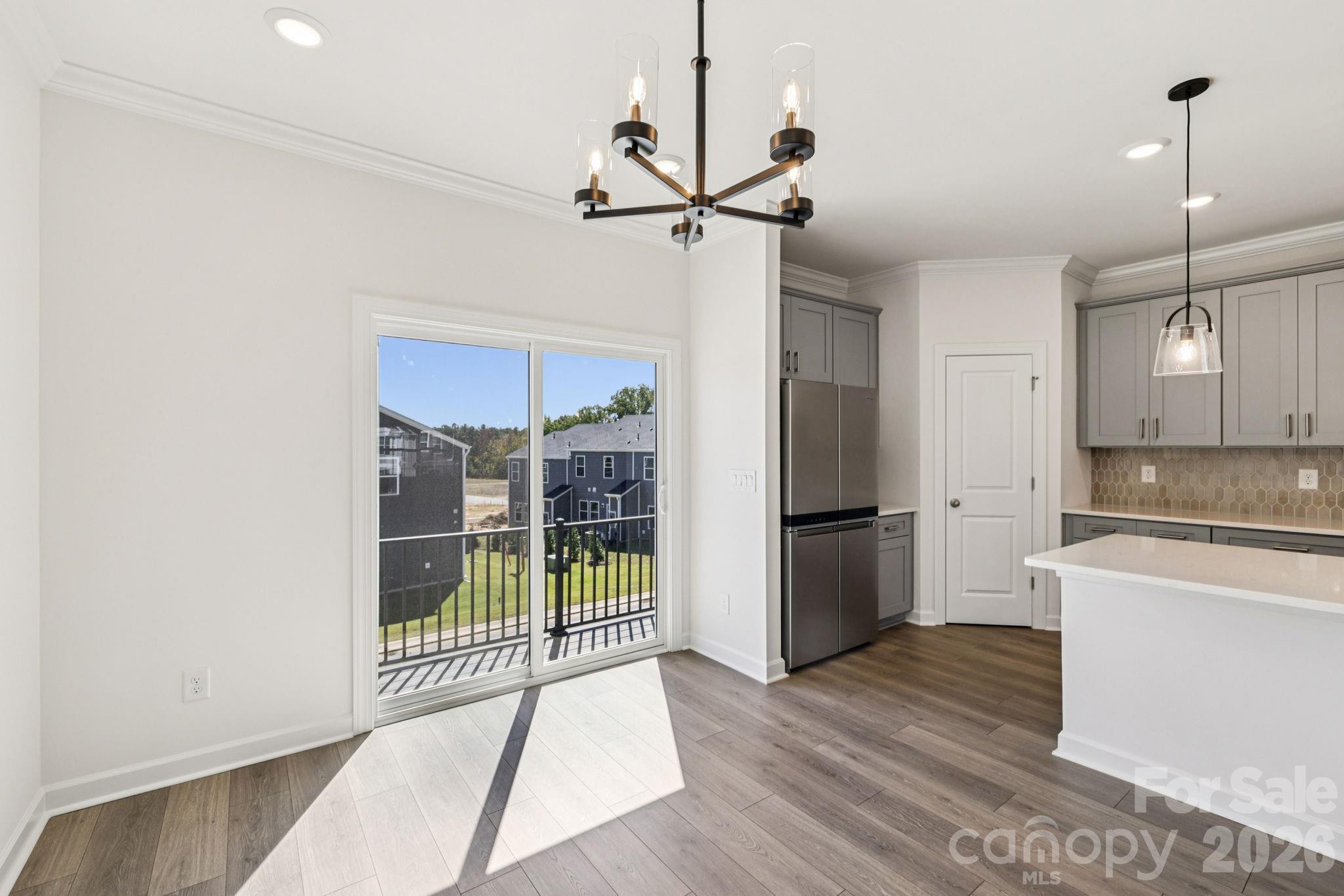 335 Golden Maple Court Fort Mill, SC 29708 - Photo 9 of 26 a view of a kitchen with refrigerator and wooden floor