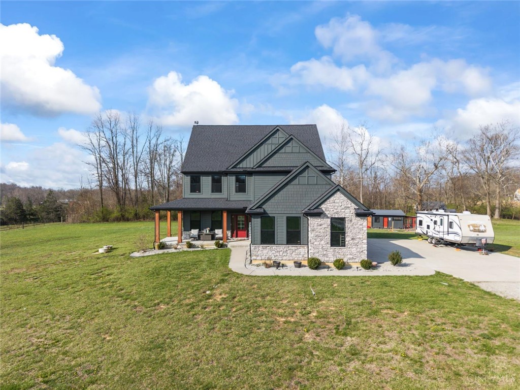 2425 Middleboro Road Clarksville, OH 45113 - Photo 4 of 91 This captivating home boasts a harmonious blend of stone and siding, set against a verdant landscape.