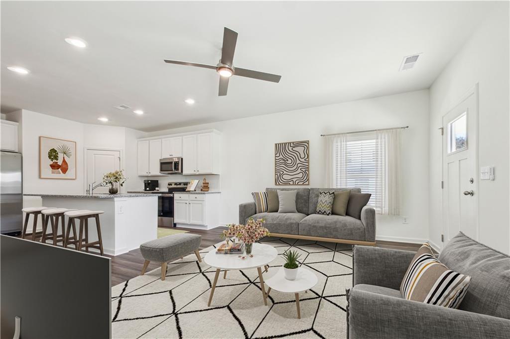 3373 Fence Road Northeast, Unit TH2 Dacula, GA 30019 - Photo 29 of 36 a living room with furniture and kitchen view