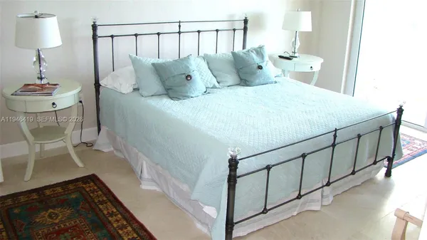 a bed sitting in a bedroom next to a lamp