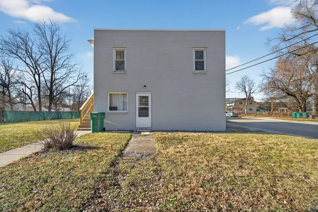 a front view of a building with a yard
