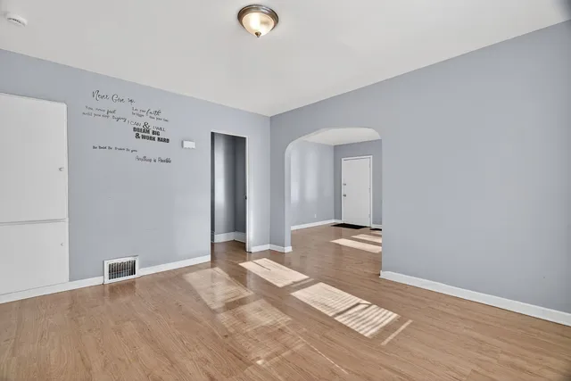 an empty room with windows and closet