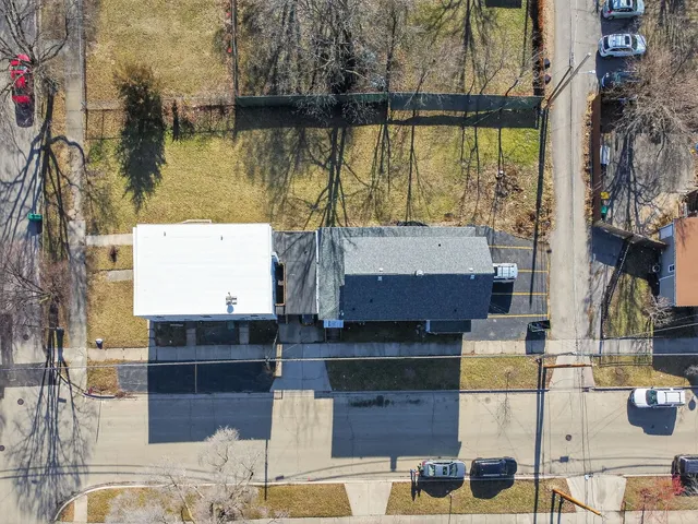 an aerial view of residential houses with outdoor space and lakeside