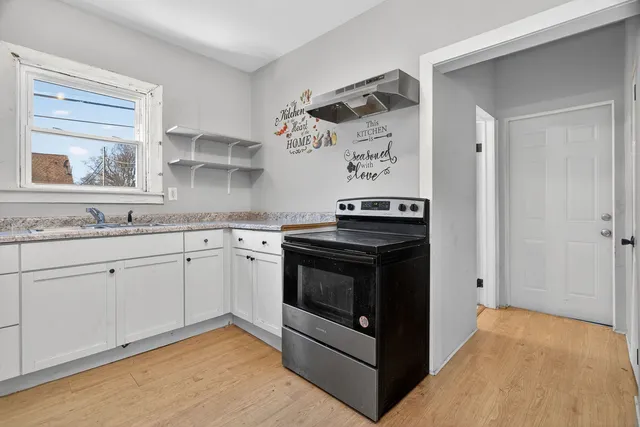 a kitchen with a refrigerator sink and cabinets