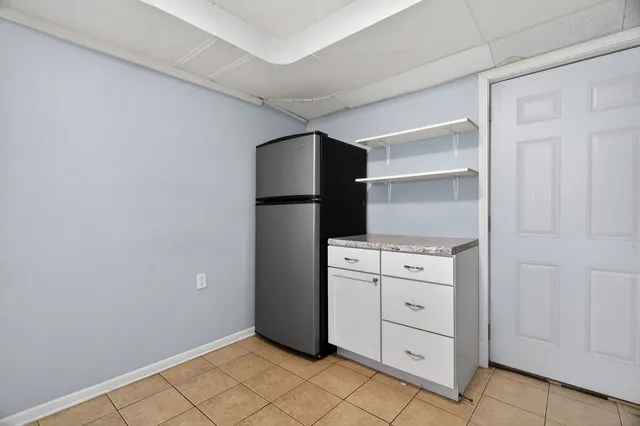 a kitchen with white cabinets and white appliances