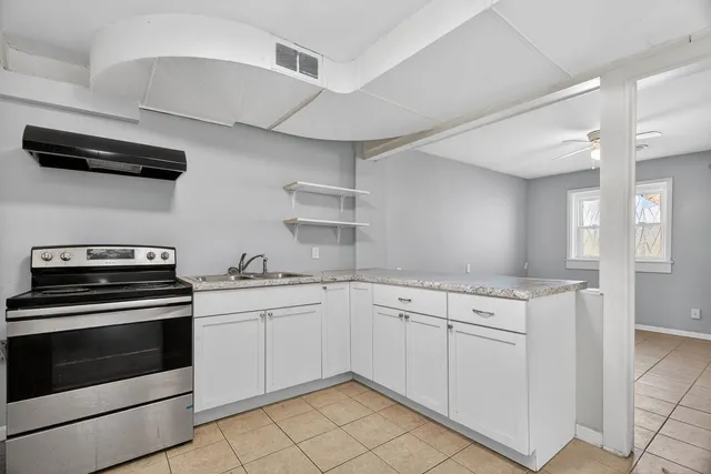 a large bathroom with a sink a mirror and a vanity