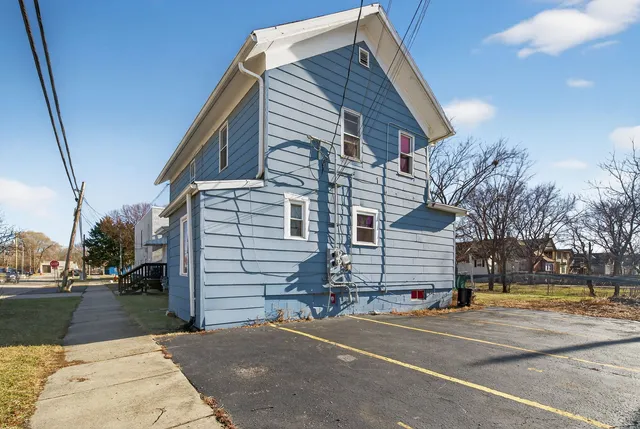 a front view of a building with a yard