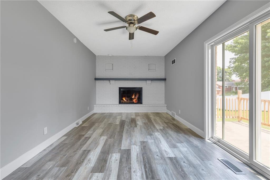 1301 Bechtel Street Monaca, PA 15061 - Photo 11 of 36 a view of wooden floor a chandelier and a fireplace in room