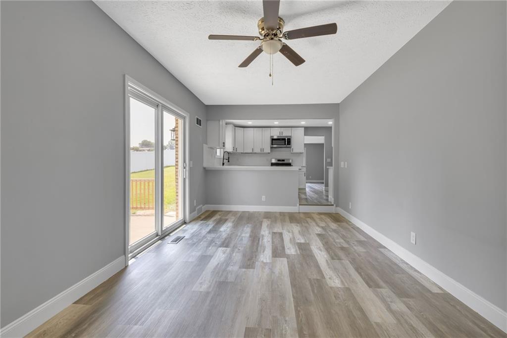 1301 Bechtel Street Monaca, PA 15061 - Photo 13 of 36 a view of a kitchen with a stove cabinets and wooden floor