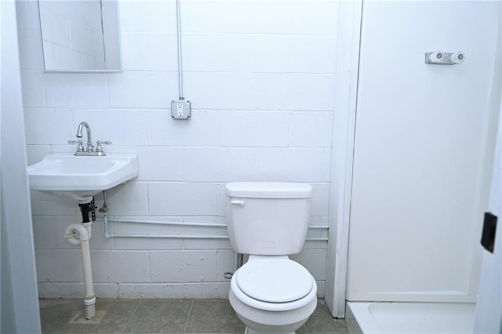 1301 Bechtel Street Monaca, PA 15061 - Photo 31 of 36 a bathroom with a toilet sink and mirror