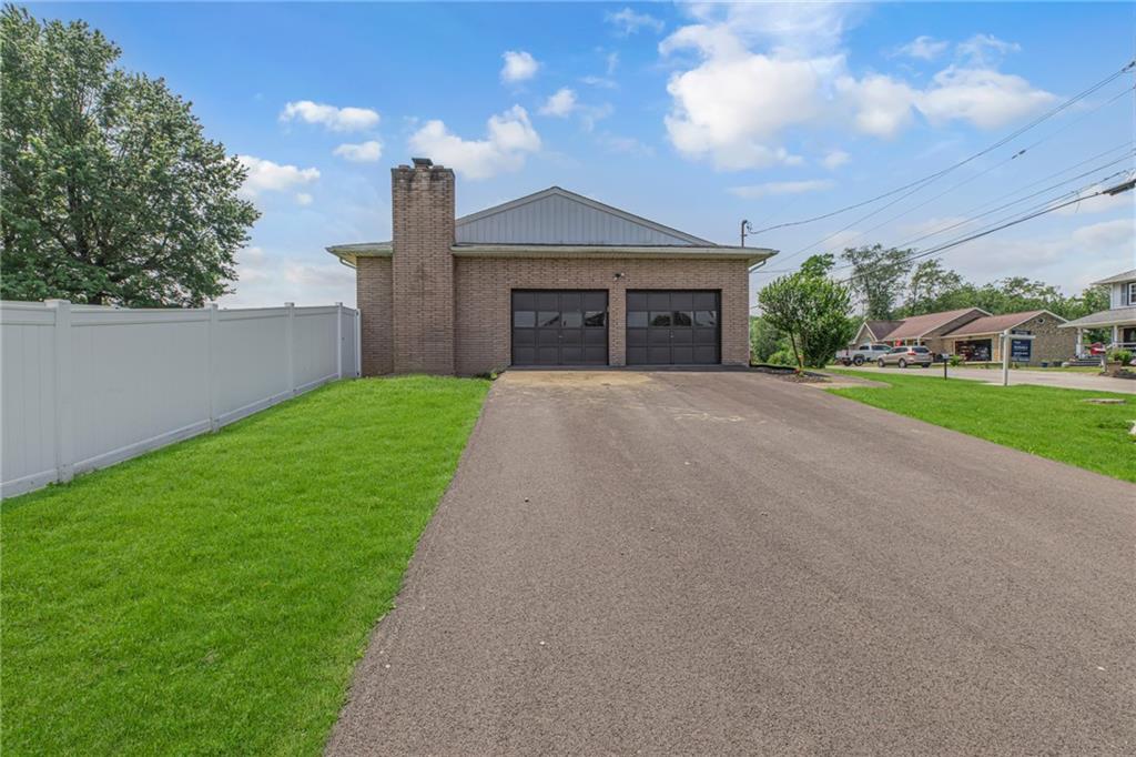 1301 Bechtel Street Monaca, PA 15061 - Photo 35 of 36 a front view of a house with a yard and garage