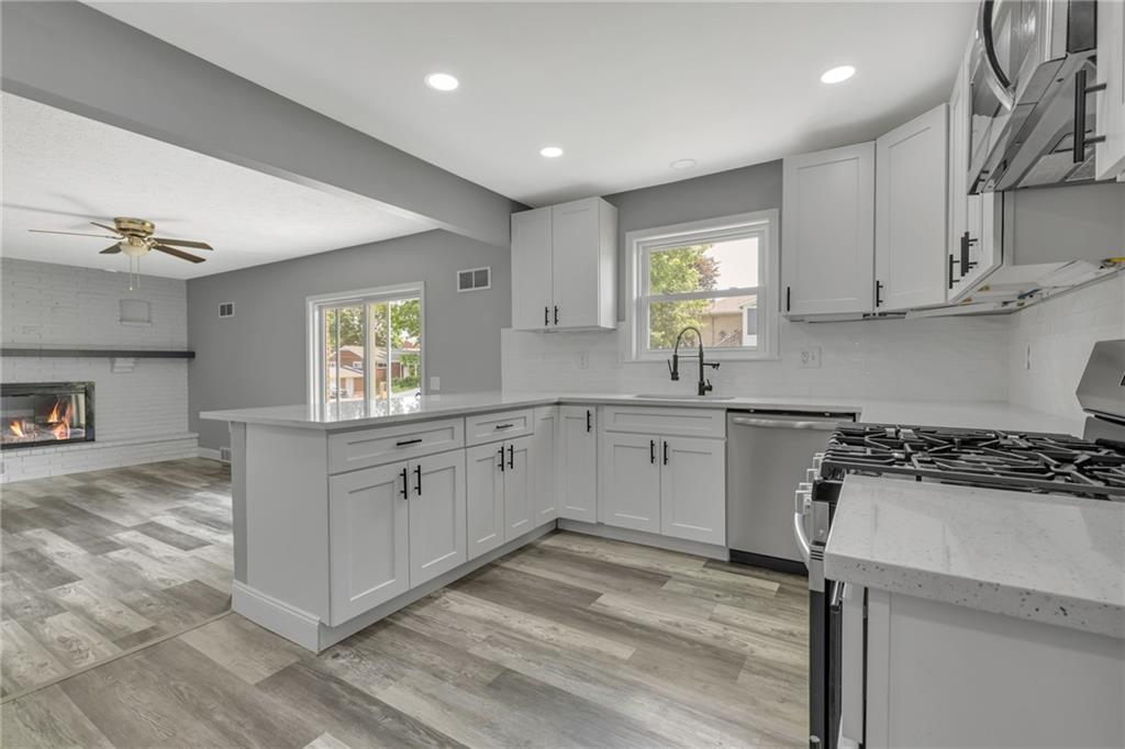 1301 Bechtel Street Monaca, PA 15061 - Photo 9 of 36 a kitchen with white cabinets stove and sink