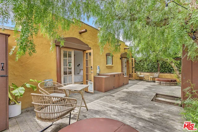 a view of a chair and tables in the patio