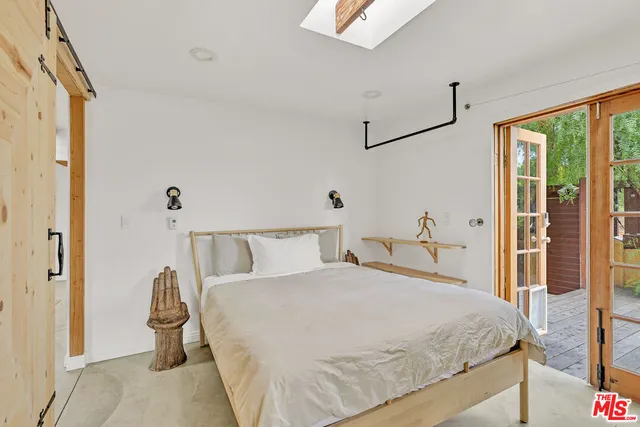 a bedroom with a bed and window