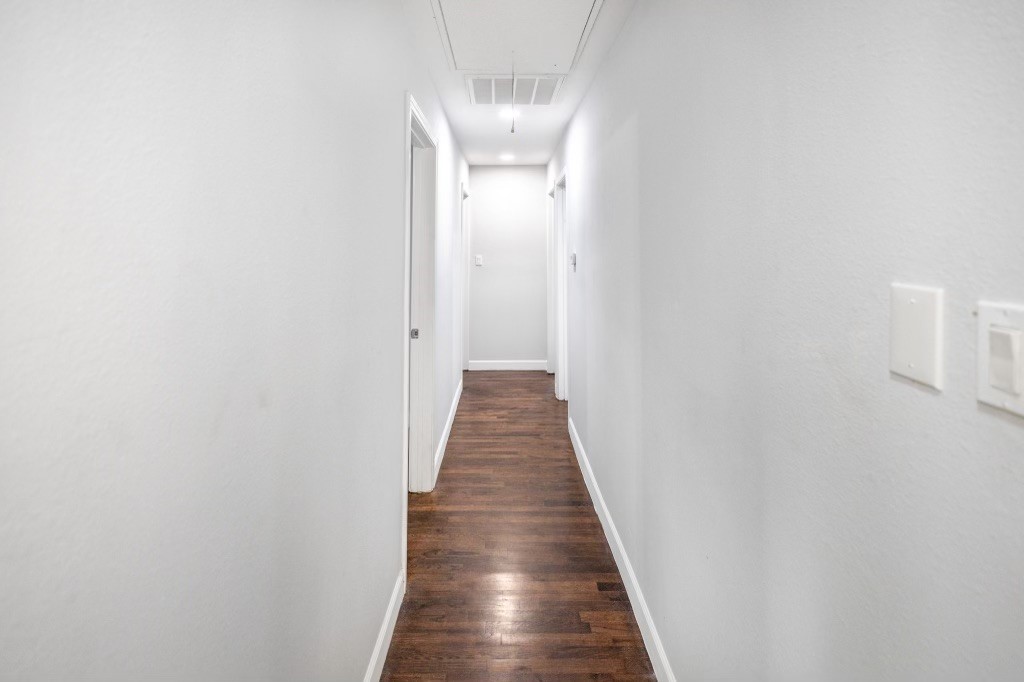 3234 Berry Street Houston, TX 77004 - Photo 19 of 34 a view of a hallway with wooden floor