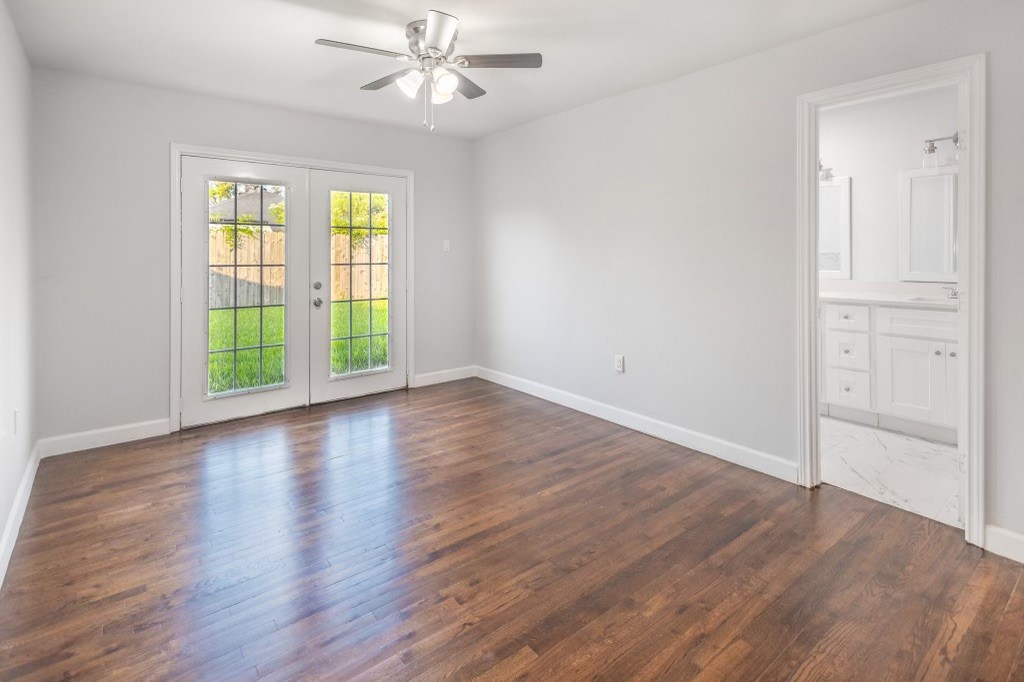 3234 Berry Street Houston, TX 77004 - Photo 21 of 34 an empty room with wooden floor chandelier fan and windows