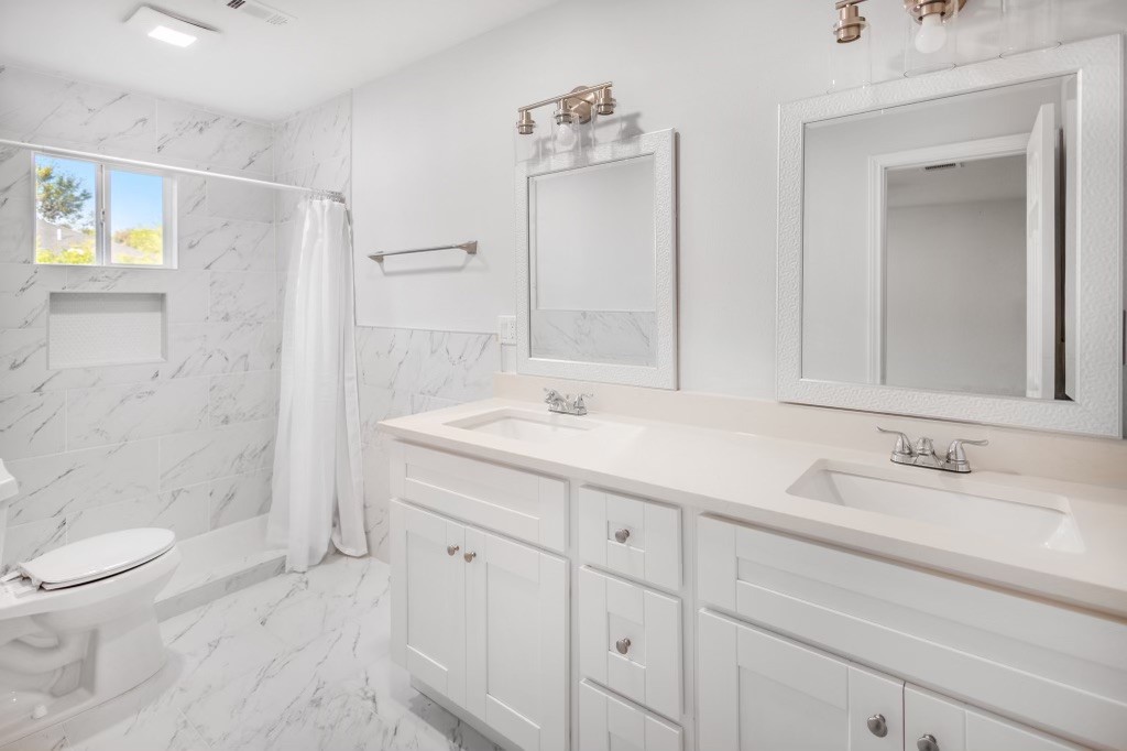 3234 Berry Street Houston, TX 77004 - Photo 23 of 34 a bathroom with a sink a toilet and shower