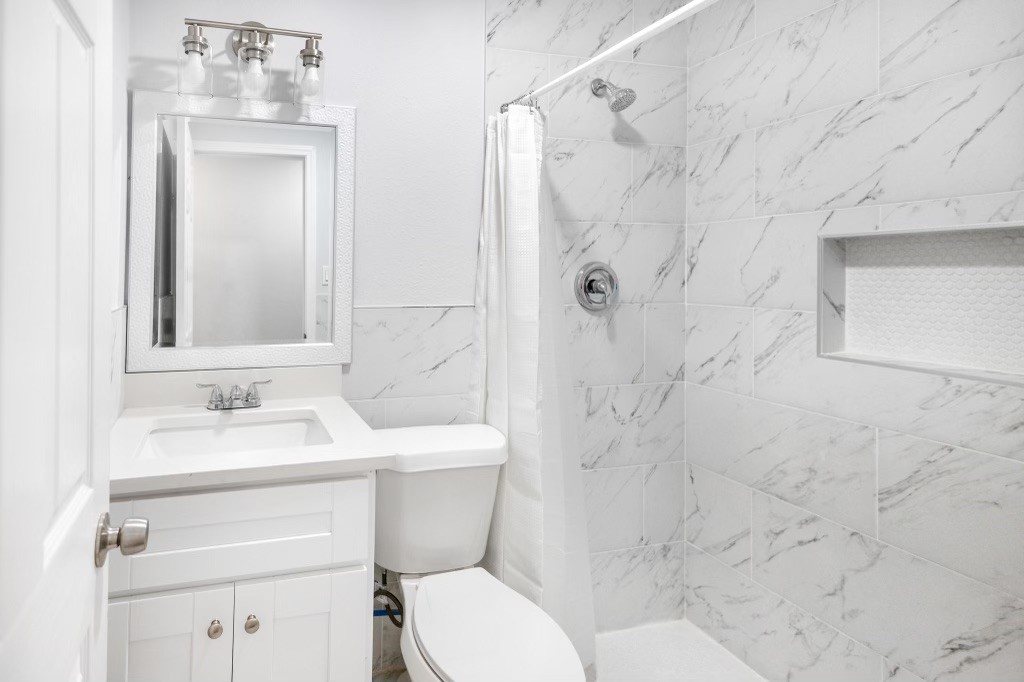 3234 Berry Street Houston, TX 77004 - Photo 24 of 34 a bathroom with a sink toilet and shower