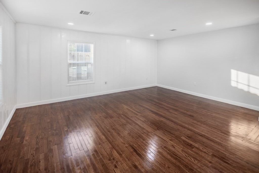3234 Berry Street Houston, TX 77004 - Photo 28 of 34 an empty room with wooden floor and windows