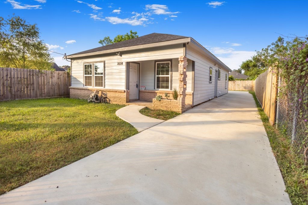 3234 Berry Street Houston, TX 77004 - Photo 3 of 34 a front view of house with yard patio and green space