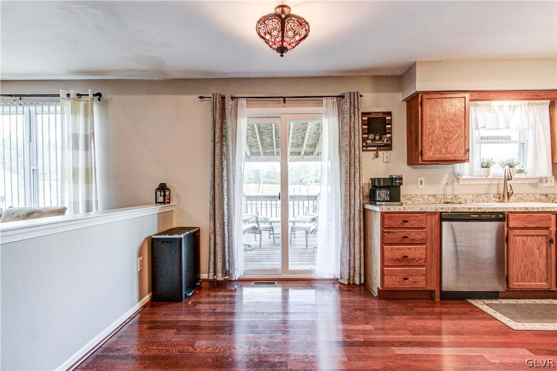 2023 Clover Mill Road Quakertown, PA 18951 - Photo 14 of 48 a kitchen with stainless steel appliances granite countertop a stove a sink and a refrigerator with wooden floors