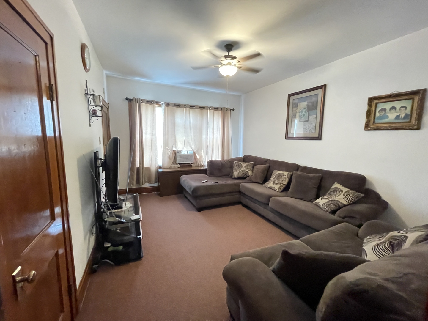 4754 South Springfield Avenue Chicago, IL 60632 - Photo 3 of 12 a living room with furniture and a flat screen tv