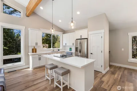 a kitchen with a table chairs refrigerator and microwave