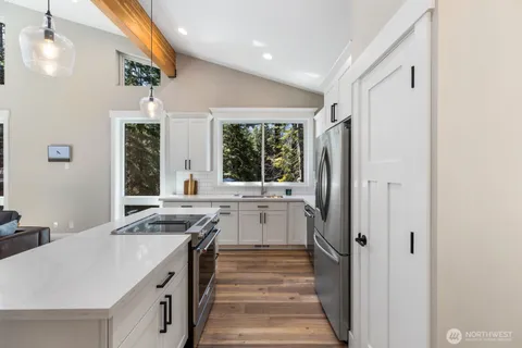 a kitchen with a sink stove and refrigerator