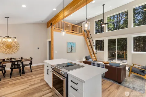 a kitchen that has a stove and a table
