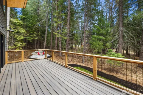 a view of a balcony with wooden floor and fence