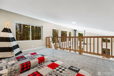 a bedroom with a bed and a large window