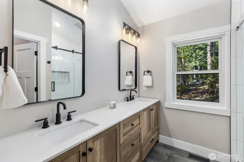 a bathroom with a double vanity sink mirror and double