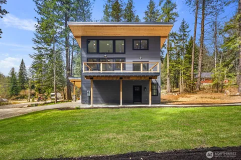 a view of a house with a yard and sitting area