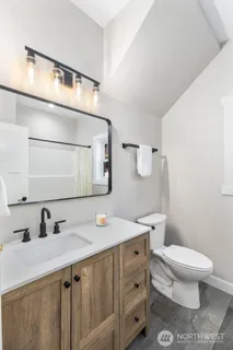 a bathroom with a sink a toilet and mirror
