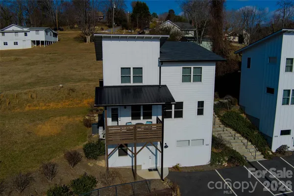 a aerial view of a house with roof deck front of house