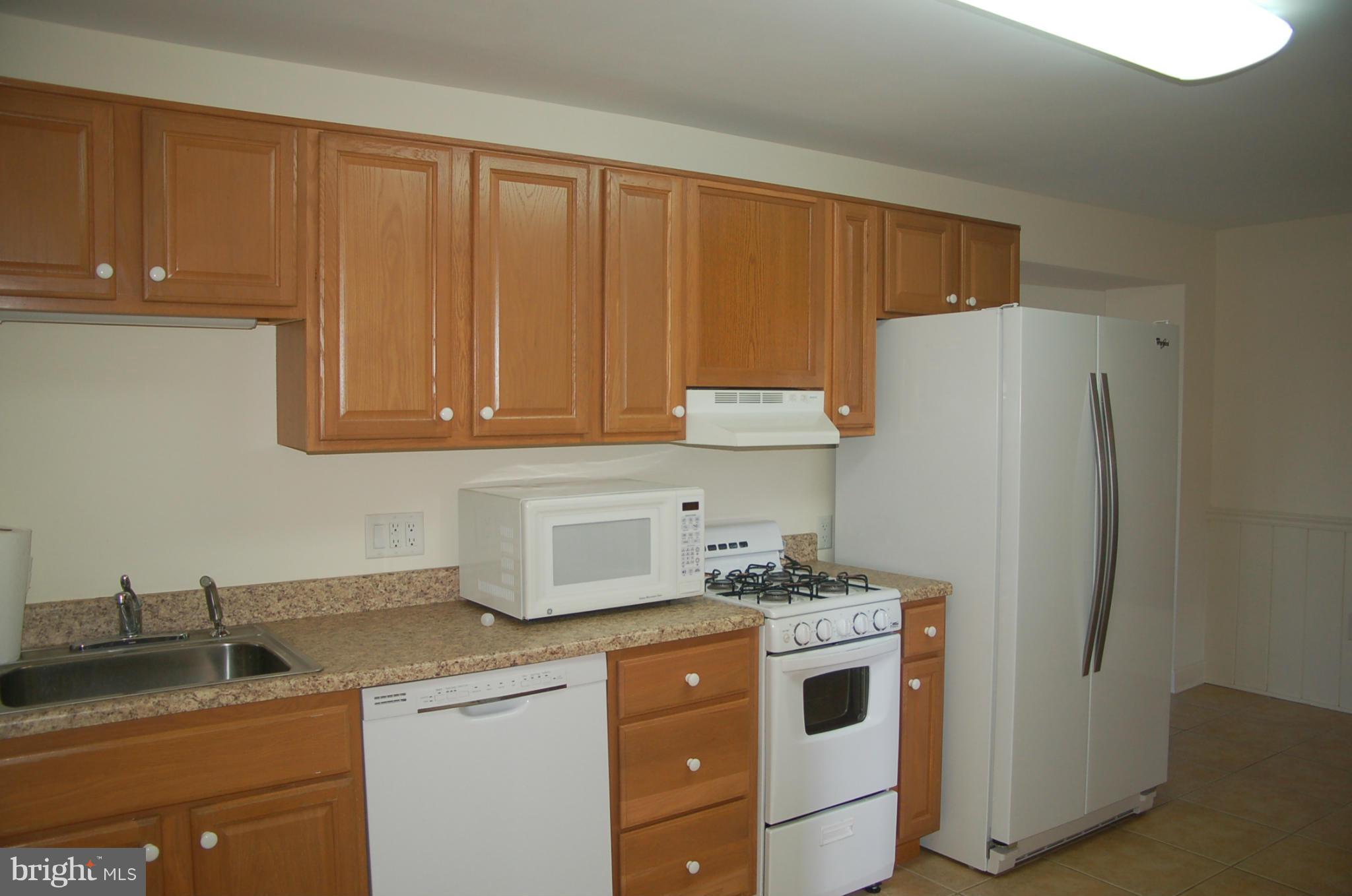 2684 Mt Ventus Road Manchester, MD 21102 - Photo 15 of 23 a kitchen with a refrigerator sink and cabinets