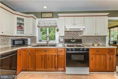2684 Mt Ventus Road Manchester, MD 21102 - Photo 9 of 23 a kitchen with stainless steel appliances granite countertop a stove a sink and a microwave
