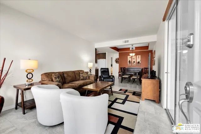 a living room with furniture and a lamp