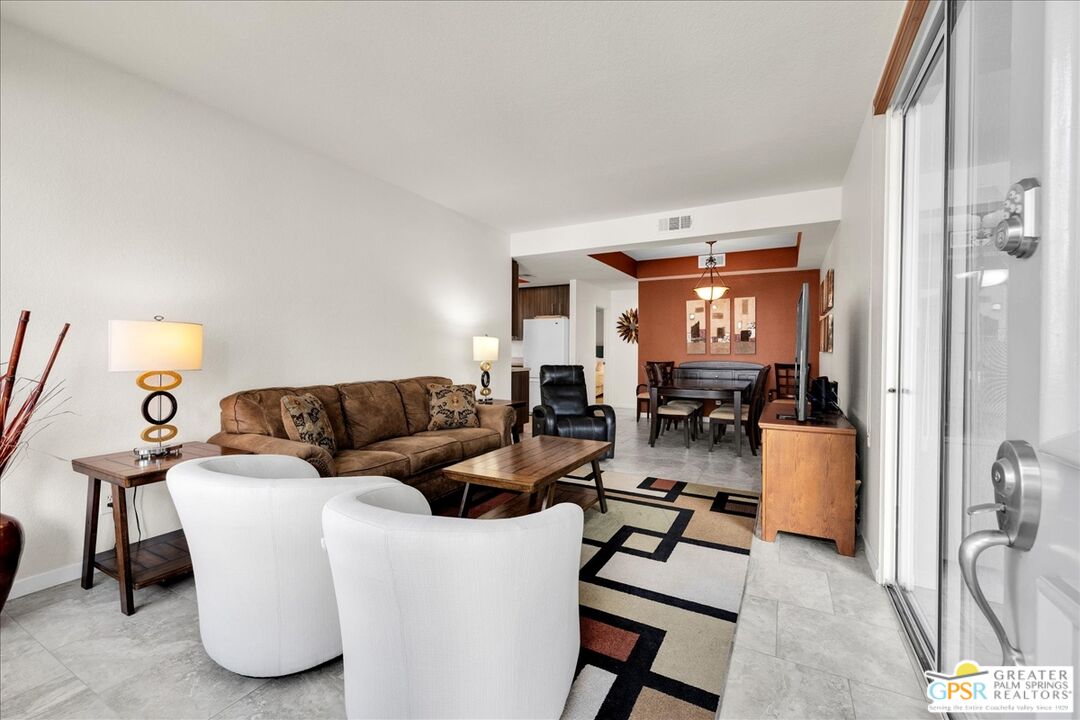401 El Cielo Road, Unit 147 Palm Springs, CA 92262 - Photo 11 of 44 a living room with furniture and a lamp